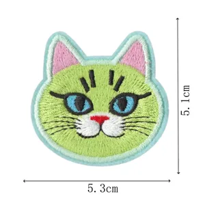 Detailed view of cute green cat embroidery patch with blue eyes, perfect for DIY clothes repair.