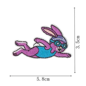 Cute swimming rabbit embroidery patch detail view, colorful sports badge for clothing DIY decor.