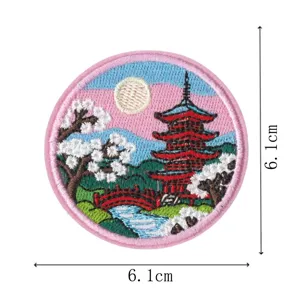 Detailed embroidery patch showing traditional Japanese pagoda, cherry blossoms and bridge detail.