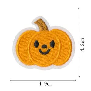 Close-up detail of the embroidered pumpkin patch showing neat stitching and vibrant color.