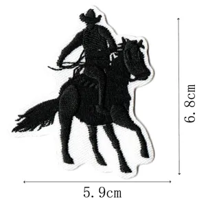 Embroidered cowboy riding a horse patch, black and white apparel clothing DIY accessory.