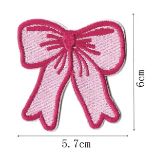 Detailed view of pink bow embroidery patch with neat stitching, ideal for DIY clothing decor.