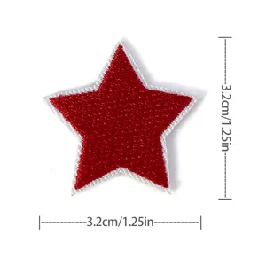 Red embroidered star patch detail, fabric applique close-up, DIY garment repair motif.
