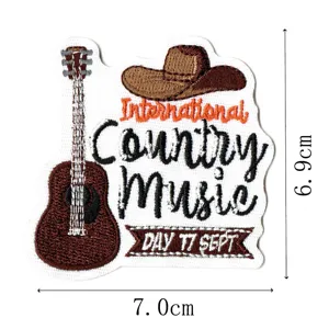 Detailed view of western country music embroidered patch with guitar and cowboy hat motif.