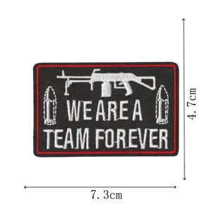 Tactical embroidered patch with machine gun design, durable morale badge for hats and bags.