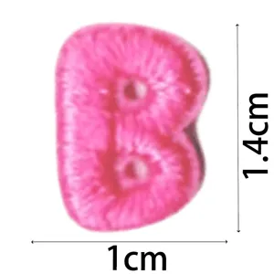 Pink embroidered letter B patch detail view, mini DIY decorative clothing accessory item.