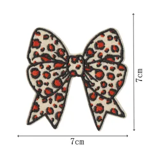 Leopard print bow embroidery patch detail view, 7x7cm decorative DIY clothing badge.