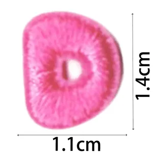 Pink embroidered alphabet letter D patch detail, mini DIY clothing accessory size view.