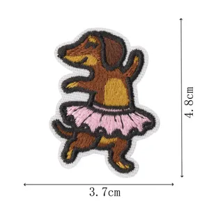Close-up detail of cute dancing dachshund embroidery patch showing fine stitching and pink tutu.