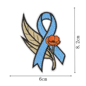 Detail view of the embroidered awareness ribbon patch with feather and poppy, size 8.2x6cm.