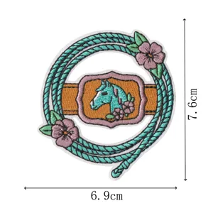 Embroidered horse patch detail showing western cowboy style flower and rope design element.