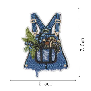 Embroidered overall patch detail featuring botanical mushroom and fern plant embroidery design.