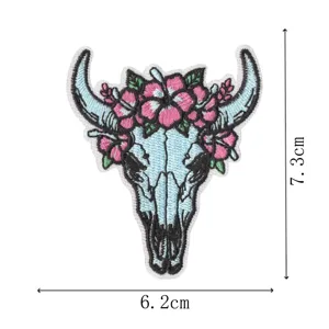 Western style steer skull embroidered patch with floral design for clothing decoration.