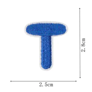 Detailed view of the blue embroidered letter T patch, showcasing fine stitching quality.