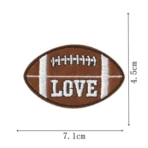 Football embroidery patch detail view, brown fabric badge with white text, apparel accessory.
