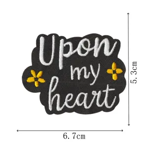 Embroidered patch featuring upon my heart quote with yellow flower accents on black.