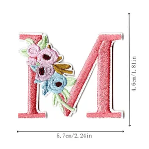 Floral letter M embroidery patch detail view, exquisite fabric DIY accessory and clothing applique.