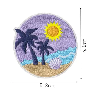 Close-up detail of a round tropical beach embroidery patch featuring palm trees and a seashell.