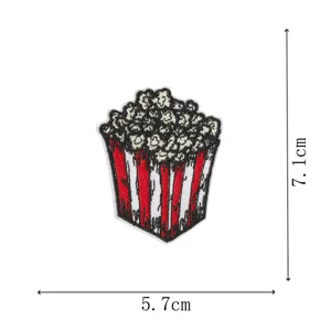 Detailed view of embroidered popcorn patch with dimension markings, fabric badge apparel accessory.