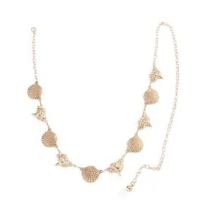 Bohemian gold metal waist chain featuring delicate shell and conch charms, perfect body jewelry.