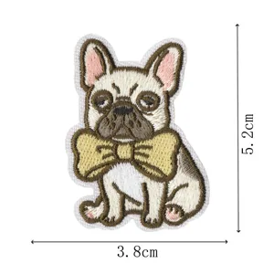 Closeup of cute French bulldog embroidered patch with bow, detailed stitching for clothes backpacks.