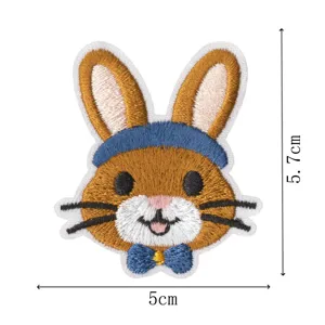Cute cartoon bunny embroidery patch with blue bow and headband, perfect for DIY clothing decor.