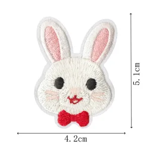 Cute white rabbit embroidered patch with red bow, perfect for DIY clothing and apparel decor.