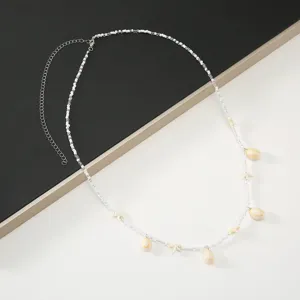 Detail view of a bohemian shell and starfish beaded waist chain for stylish summer outfits.