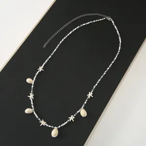 Shell starfish beaded waist chain detail, white beads design for summer beach style.
