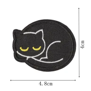 Detail view of the cute sleeping black cat embroidered patch showing its size and stitching.