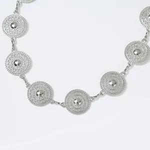 Metal waist chain with vintage filigree disc design, elegant dress accessory for women.