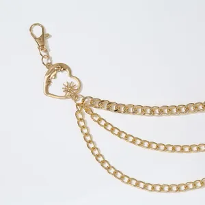Detailed view of the multi-layer gold waist chain featuring a sun and moon heart pendant.