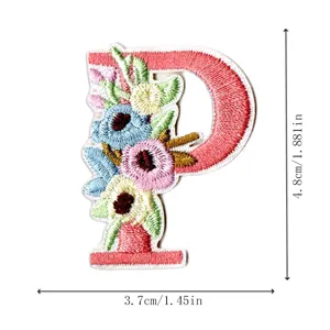 Close-up detail of letter P embroidered patch with colorful floral design and stitching.