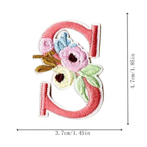 Embroidery letter S patch detail, floral embroidered DIY clothing accessory badge close-up.
