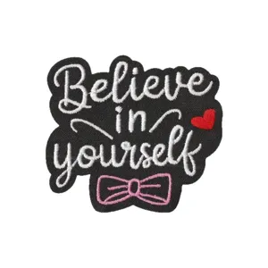 Embroidered patch with Believe in yourself quote, cute pink bow and red heart on black fabric.