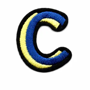 Detailed shot of a colorful embroidered letter C patch with blue and yellow stripes for DIY.