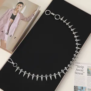 Detailed shot of punk style silver metal spike chain waist accessory with edgy design.