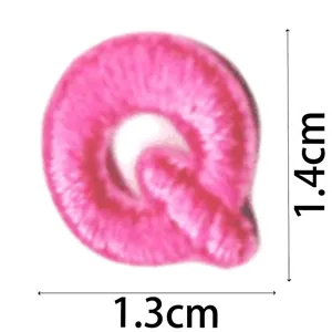 Pink embroidered letter Q patch detail, mini DIY clothing accessory and apparel decoration.