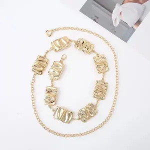 Retro irregular metal chain belt with wavy rectangular links, gold fashion waist accessory.