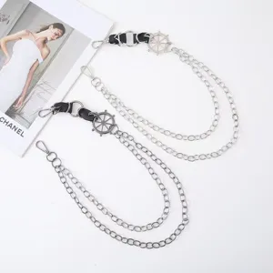 Detailed shot of double layer metal pants chains with helm pendant, punk style accessory.
