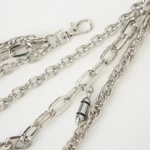 Close-up detail shot of multi-layer metal pants chain with bullet pendant and lobster clasp.