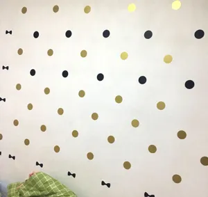 Nordic style polka dot and bow wall stickers detail showing cute kids room wall decoration setup.