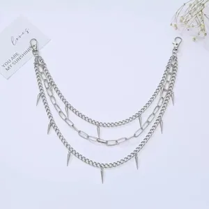 Detail shot of multi-layer silver metal waist chain with punk spike pendants for street style.