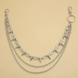 Detail shot of the multi-layered punk style metal waist chain featuring sharp spike pendants.