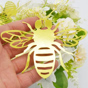 Gold 3D hollow bee wall sticker detail, metallic decorative insect for party and home decor.