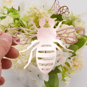 Close-up detail of rose gold 3D hollow bee wall sticker, elegant metallic finish for decor.