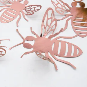 Close-up view of rose gold 3D hollow bee wall stickers, showing fine cutout wing details.