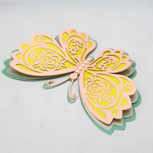 Close-up detail of 3D layered hollow butterfly wall sticker with pearls for home decor.