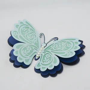 Close-up detail of 3D layered hollow paper butterfly wall sticker with pearl decor for wedding.