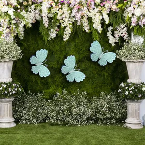 Detailed scene of 3D hollow butterfly wall stickers with pearls for wedding and party decor.